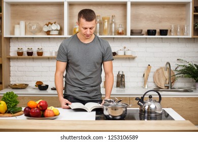Paleo, Keto, Detox Diet Food, Slimming And Weight Loss. Fit Muscled Man Reading Recipe Book Before Cooking