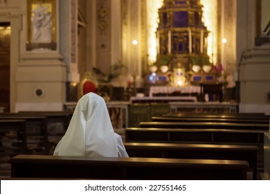 PALERMO, ITALY - OCTOBER 22, 2014: Nun praying in Metropolitan Cathedral of Assumption of Virgin Mary; cathedral church of  Roman Catholic Archdiocese of Palermo, Sicily, in southern Italy.