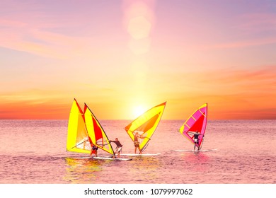 Palermo, Italy, October 31, 2017: Group Of Windsurfers Catch Wind In The Sea At Sunset