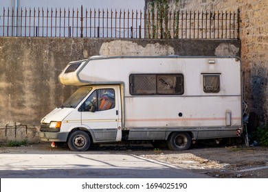 PALERMO, SICILY - FEBRUARY 8, 2020: The Old Abandond Ford Transit RV Vehicle In The Streets Of Palermo. The Wreck Of A Caravan Is No Longer Used For Travelling And May Serve To Homeless People.