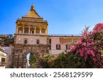 Palermo, Sicily. Porta Nuova, old wall city gate, statue reliefs and bougainvillea