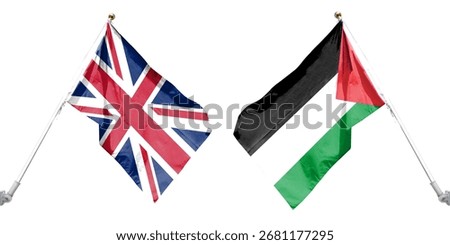 Palestinian and British flags flutter against a clear sky.