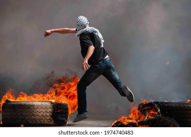 Palestinian demonstrators burn tyres and throw rocks in the West Bank, Palestinian Territories, Palestine, May 15,2021
