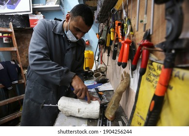 Palestinian doctor Muhammad al-Khalidi works on making artificial limbs by self-effort in his private clinic in Rafah, in the southern Gaza Strip, on January 28, 2021. Photo by Abed Rahim Khatib - Shutterstock ID 1904256244