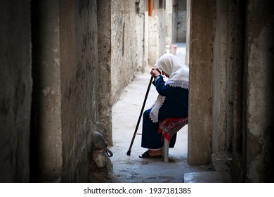 A Palestinian Woman Sits In The Old City Of The West Bank City Of Hebron On May 8, 2016