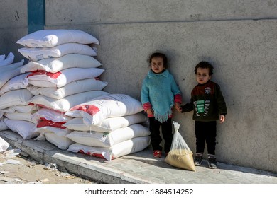 Palestinians Receive Food Aid From A Distribution Center Affiliated With The UN Relief And Works Agency For Palestine Refugees (UNRWA) In The Rafah Refugee Camp, Southern Gaza Strip, On Dec 30, 2020.