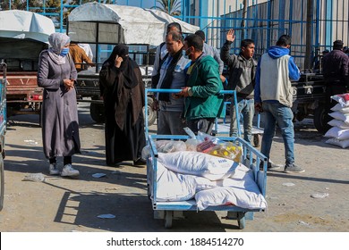 Palestinians Receive Food Aid From A Distribution Center Affiliated With The UN Relief And Works Agency For Palestine Refugees (UNRWA) In The Rafah Refugee Camp, Southern Gaza Strip, On Dec 30, 2020.