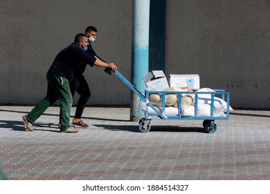 Palestinians Receive Food Aid From A Distribution Center Affiliated With The UN Relief And Works Agency For Palestine Refugees (UNRWA) In The Rafah Refugee Camp, Southern Gaza Strip, On Dec 30, 2020.