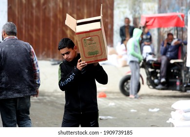 Palestinians Receive Food Aid From A United Nations Relief And Works Agency (UNRWA) Distribution Centre. In The Rafah Refugee Camp In The Southern Gaza Strip, 04 February 2021. 