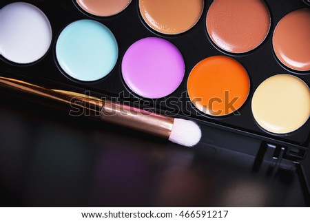 Palette concealer and correctors. Make-up base. Isolated on black background