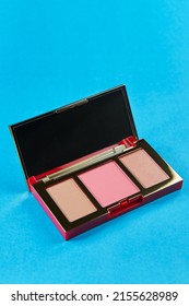 Palette Of Contouring Products For The Face On A Blue Background, Blush, Bronzer