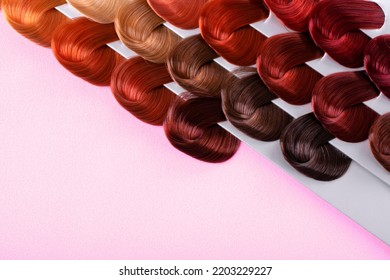 Palette With Hair Dye Swatches Of Different Colors On Pink Background. Dyeing Hair Into Assorted Shades At Hairdresser. Mockup With Copy Space