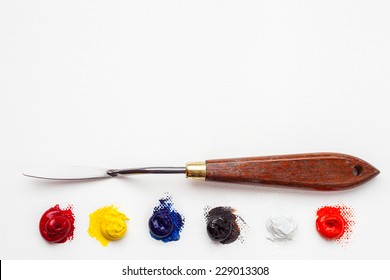 palette knife and oil paint on white artist canvas - Powered by Shutterstock