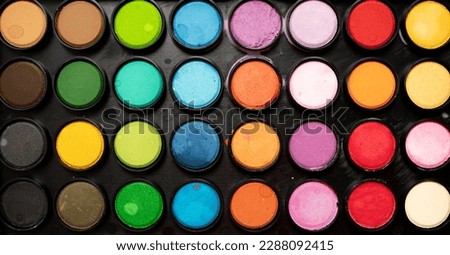 palette of multi-colored watercolor paints close-up