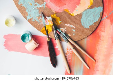 Palette with paints and brushes on colorful background, top view.  - Powered by Shutterstock