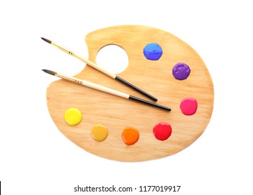 Palette with paints and brushes on white background, top view