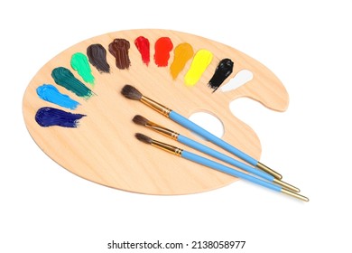 Palette with paints and brushes on white background, top view. Artist equipment
