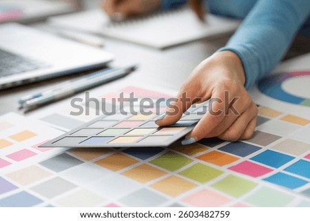 Palette Planning and Creative Process. A designer analyzing color options and textures.