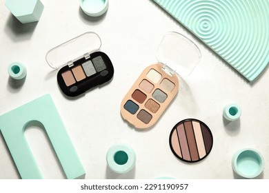 Palettes of eyeshadows with podiums on white background Stock Photo