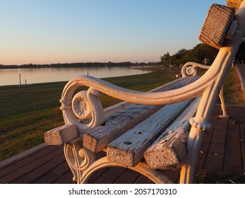 Palic, Serbia September 10, 2021. Metal bench overlooking Lake Palic. The seat is white. R letter on metal armrest. Golden hour in a quiet family resort. Tourist destination near the Hungarian border - Shutterstock ID 2057170310