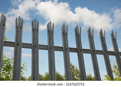 Palisade  Security Fencing Against A Bright Blue Sky