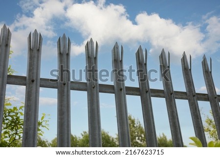 Palisade  security Fencing against a bright blue sky