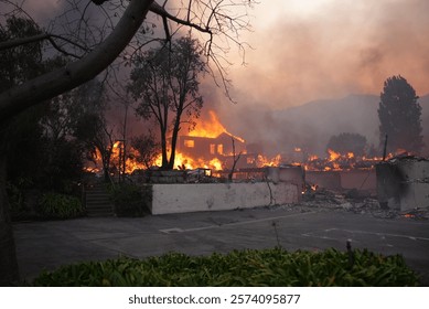 Palisades fire burning down a large home