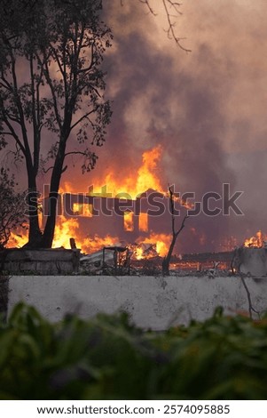 Palisades fire burning down a large home