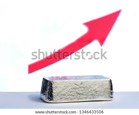 Palladium bar on the white background with a red growth pointer. Selective focus. 