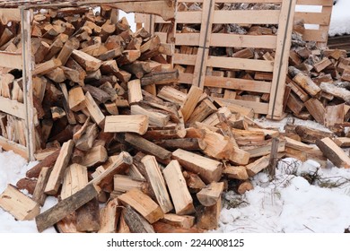 Pallet of firewood. Wooden box with firewood. Chopped and hand-folded in a crate for sale or for storage in a cottage. transport by pallet truck. - Shutterstock ID 2244008125