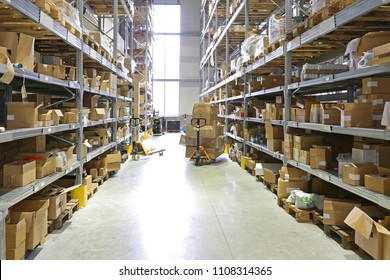 Pallet Jack With Boxes In Fulfillment Warehouse Aisle