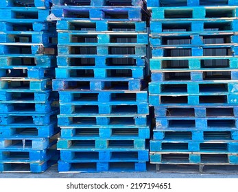 a pallet shipping receiving wood stacked palates trucking logistics wooden generic strong support rack warehouse painted blue cargo