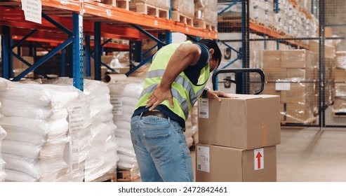 Pallet truck, man and back pain in warehouse with transport, safety and storage for distribution or delivery. Freight operator, logistics and stock in cardboard for shipping, cargo and inventory - Powered by Shutterstock