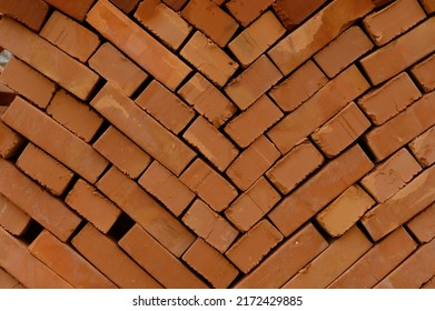 Pallets And Packages Of Freshly Produced Red Bricks In A Construction Warehouse On The Street. Concept Of Repair And Building Materials