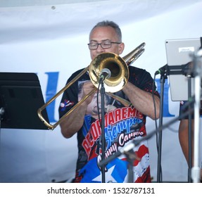 PALM BAY, FL -USA- OCTOBER 12 2019: A Trombone Player From Plena Mar Latino Group Performs The Puerto Rico Folk Music During Viva Brevard Festival. The Event Celebrate The Hispanic Heritage.