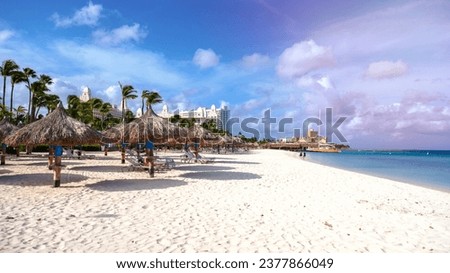 Palm Beach Aruba Caribbean, white long sandy beach with palm trees at Aruba Antilles.