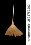 Palm fiber broom with rattan handle and black background 