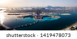 The Palm island panorama with Dubai marina rising in the background aerial view