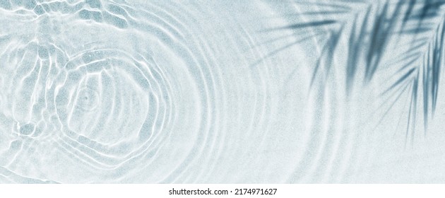 palm leaf shadow on abstract white sand beach background, sun lights on water surface, beautiful abstract background concept banner for summer vacation at the beach - Shutterstock ID 2174971627
