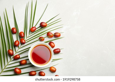 Palm Oil In Bowl, Tropical Leaf And Fruits On Light Table, Flat Lay. Space For Text