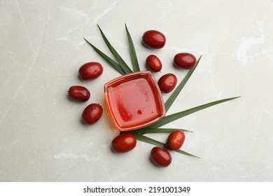 Palm Oil In Glass Bowl, Tropical Leaf And Fruits On Light Table, Flat Lay