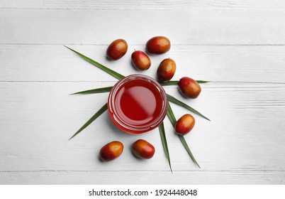 Palm Oil In Glass Jar, Tropical Leaf And Fruits On White Wooden Table, Flat Lay