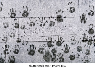 Palm prints of people on a cold snowy frosted wall to support illegally arrested Alexei Navalny in the centre of Moscow during a political protest rally. Translation: freedom to Alexey