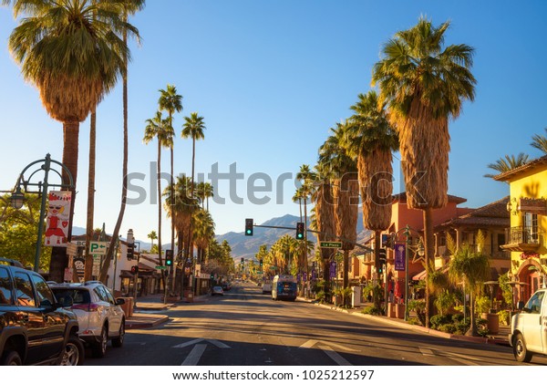 Palm Springs,\
California, USA - December 27, 2017 : Scenic street view of Palm\
Springs at sunrise. It is a desert resort city in Riverside County\
within the Coachella\
Valley.