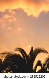 Palm tree and clouds during sunset. Abstract defocused background. Vertical format. 