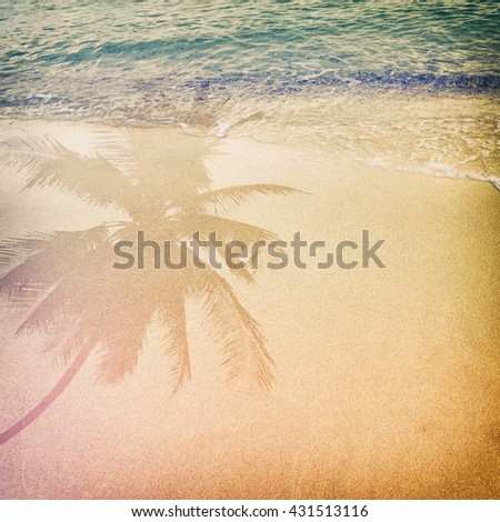 Palm tree shadow on the sandy beach with ocean wave - free space. vintage color tone effect