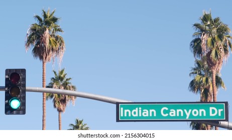 Palm Trees And Blue Sky, Palm Springs Resort City Near Los Angeles, Street Road Sign, Semaphore Traffic Lights On Crossroad. California Desert Valley Summer Road Trip On Car, Travel USA. Indian Canyon