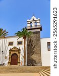 Palm trees at Iglesia de Nuestra Señora de los Ángeles, an old church in the city center of Garachico, a small village on Tenerife, Canary Islands, Spain