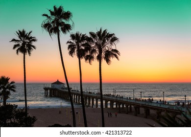 Palm Trees And Pier At Sunset On Los Angeles Beach. Vintage Processed. Fashion Travel And Tropical Beach Concept.