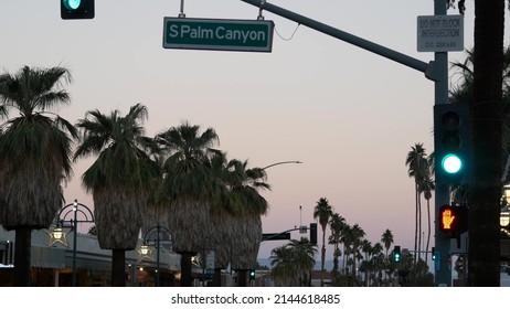 Palm Trees And Sky, Palm Springs Street, City Near Los Angeles, Semaphore Traffic Lights On Crossroad. California Summer Road Trip On Car, Travel USA. Road Sign Palm Canyon, Twilight Dusk After Sunset